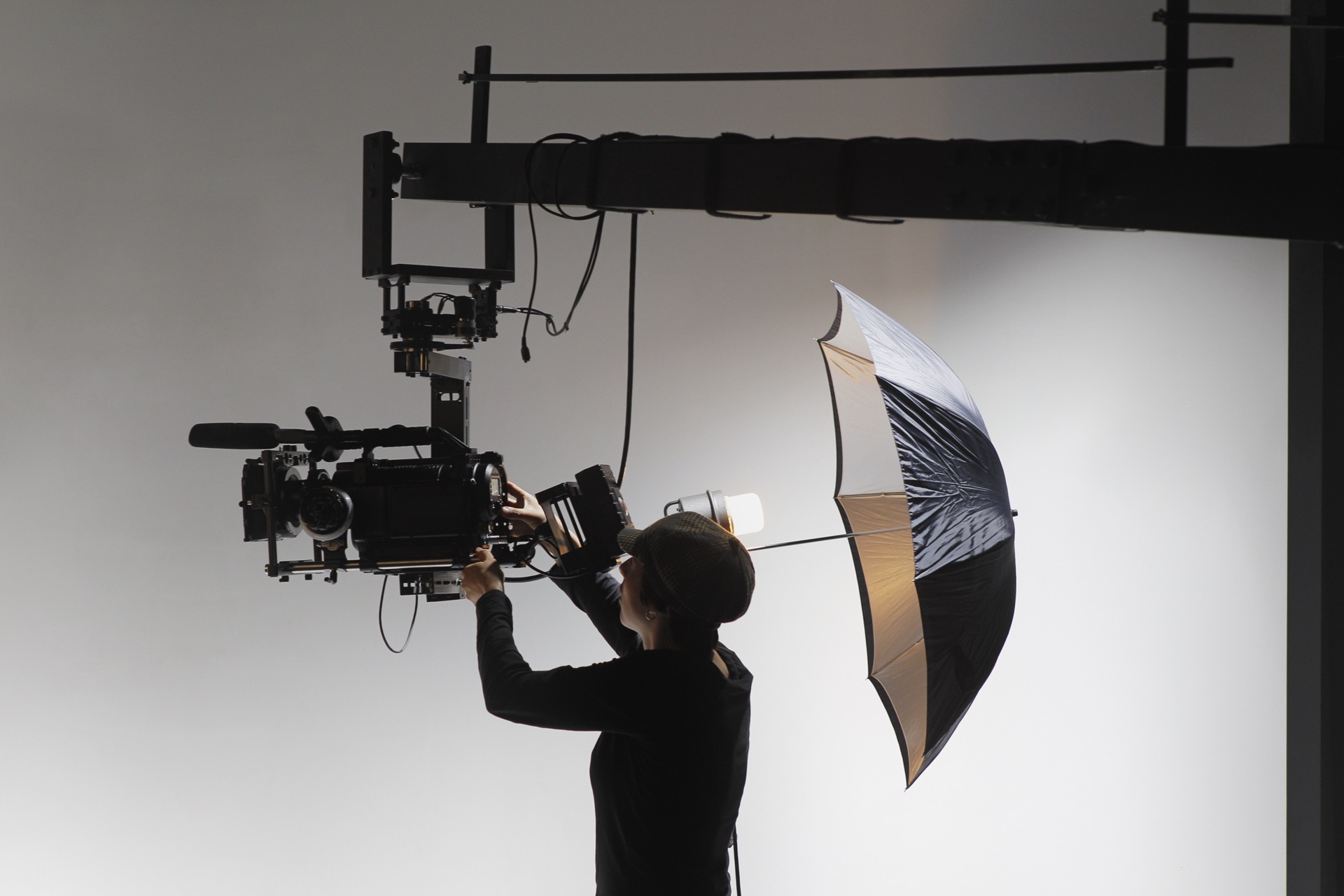 Camera operator adjusting a light on set